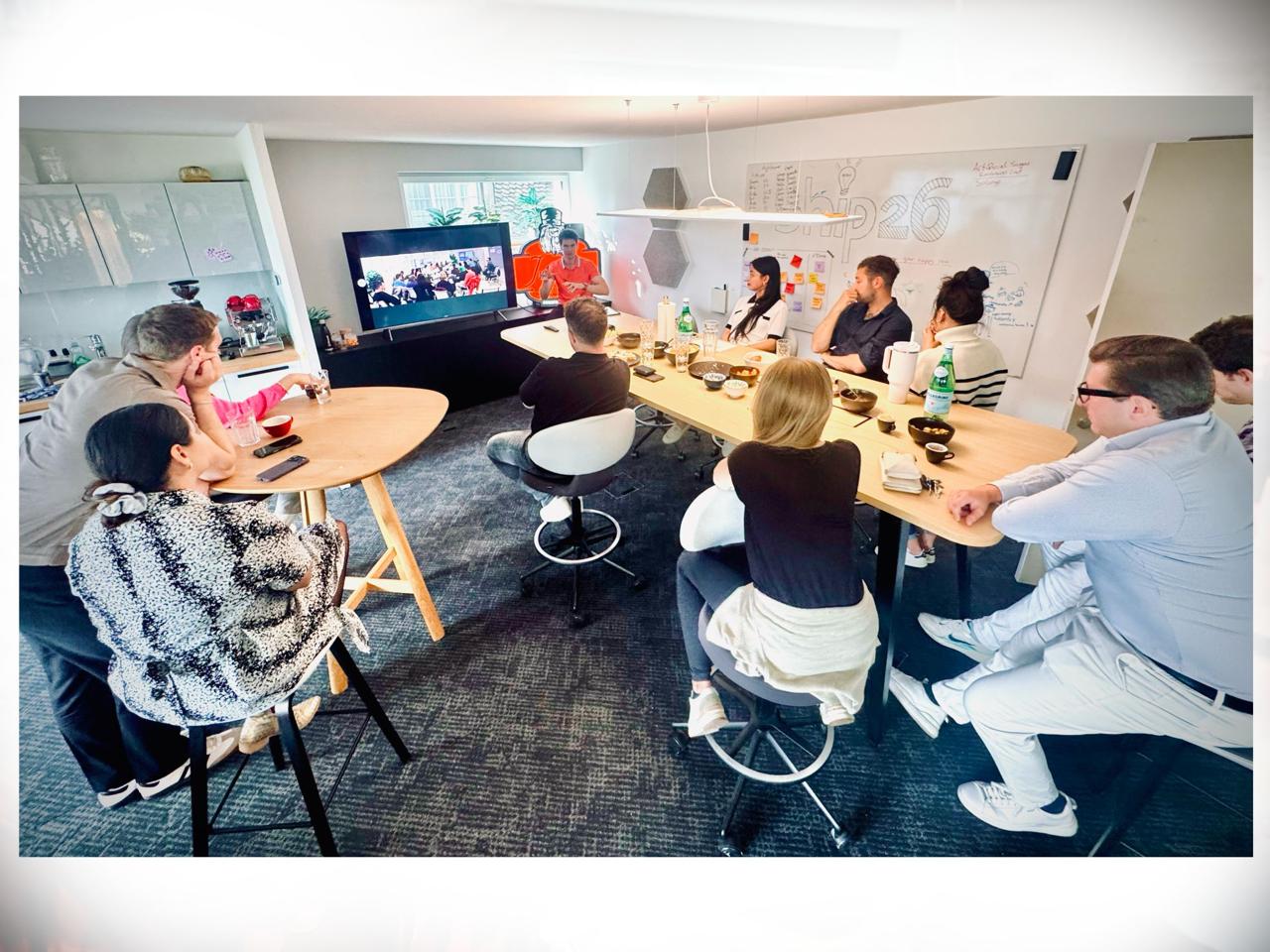 The Ship26 crew around the table during the China debrief session