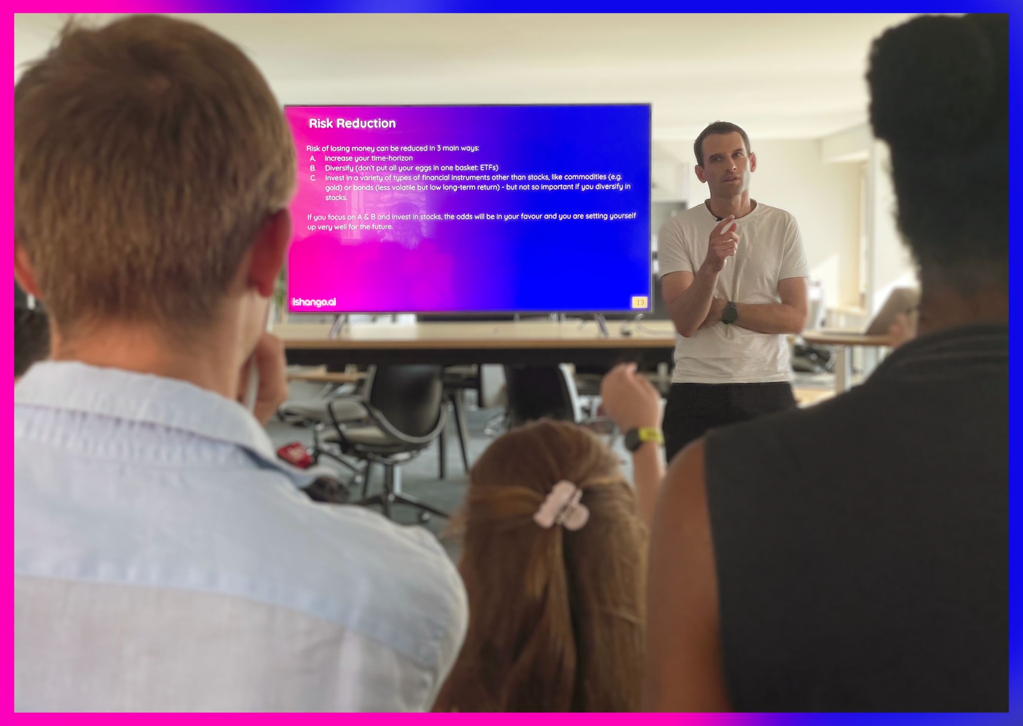 Oliver Angélil at the screen at Ship26, walking the room through his three ways to reduce risk: a longer time horizon, diversification through ETFs, and instruments beyond stocks